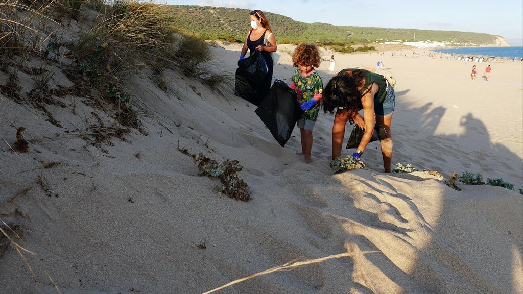 Voluntarios recogiendo basura en las dunas próximas al faro de Trafalgar