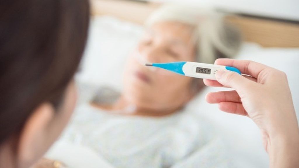 termómetro marcando fiebre