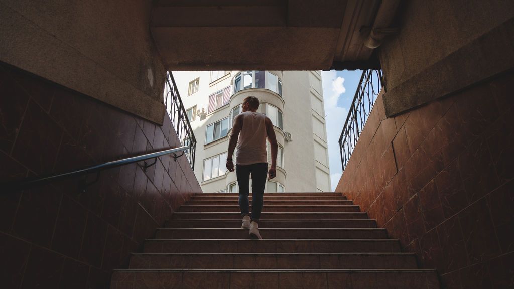 young-man-climbing-stairs-in-pedestrian-subway