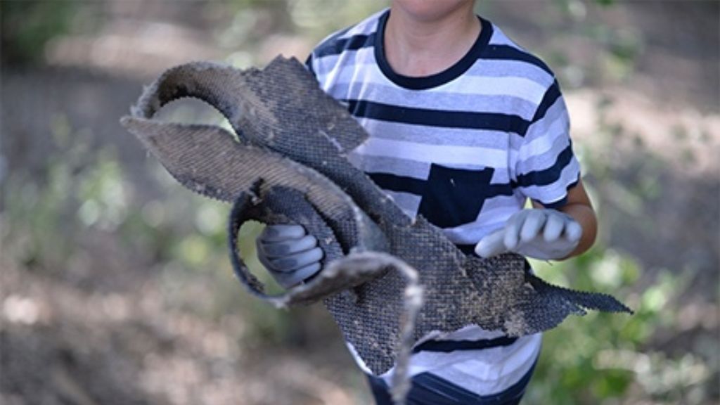 Un niño recogiendo basuraleza del entorno ambiental