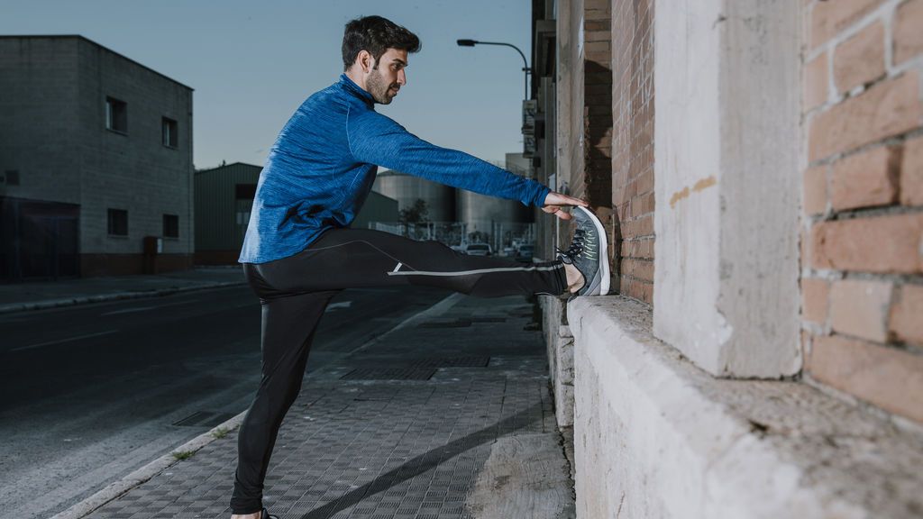 athletic-man-warming-up-on-street