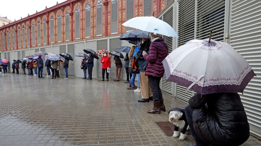 Varios votantes hacen cola en uno de los colegios electorales del Mercat de Sant Antoni