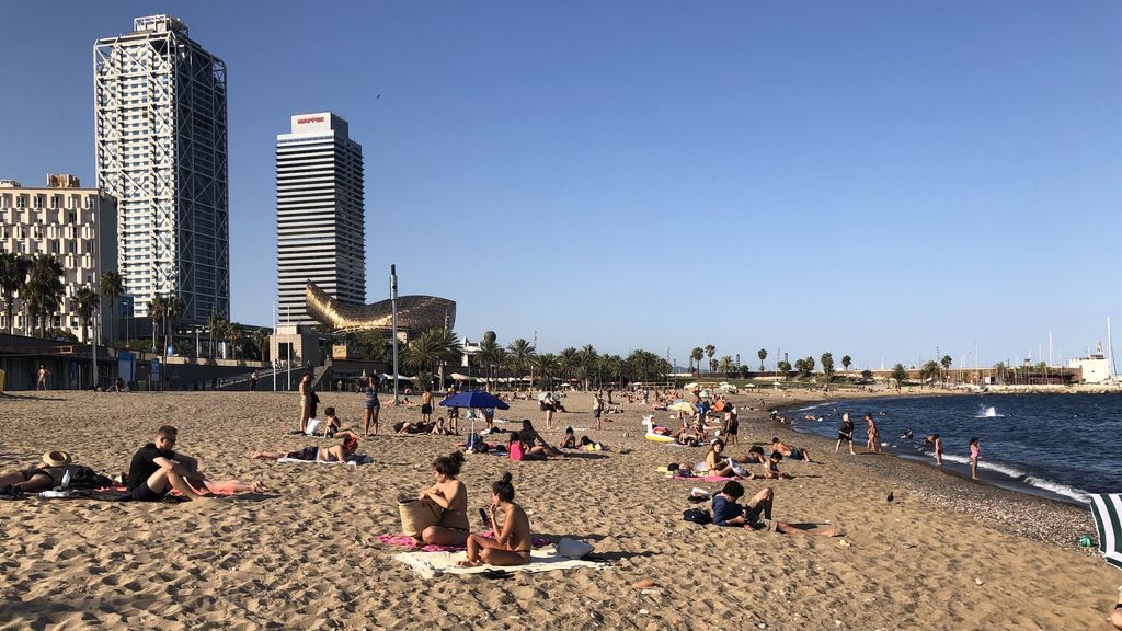 Bañistas toman el sol en la playa de Somorrostro Bañistas toman el sol en la playa de Somorrostro