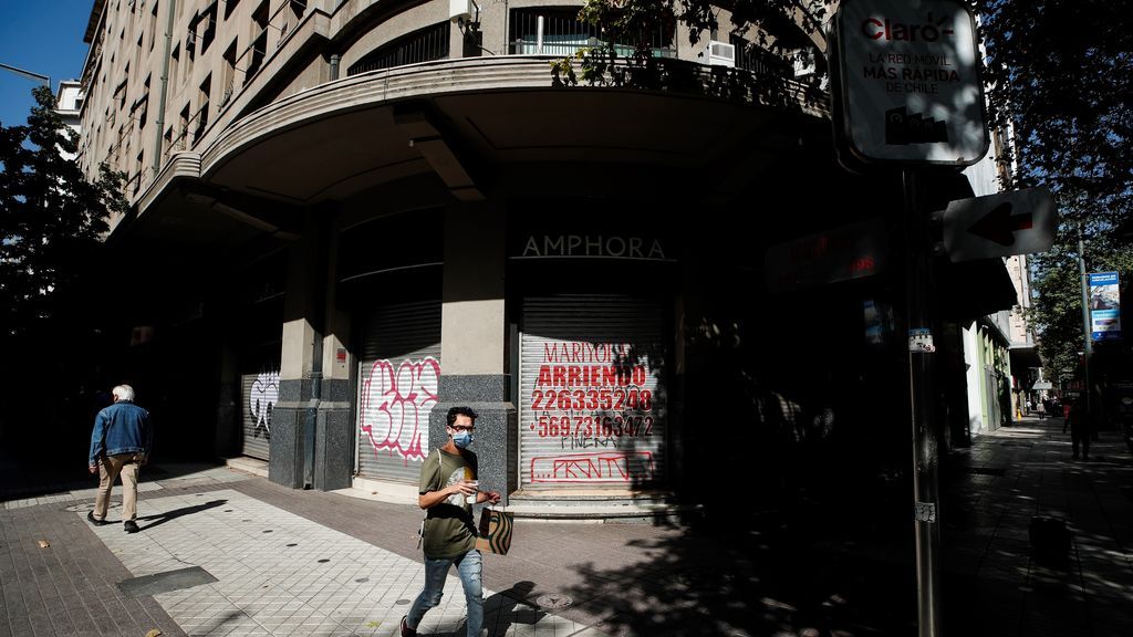 Personas caminan por una calle vacía en el centro de Santiago (Chile)