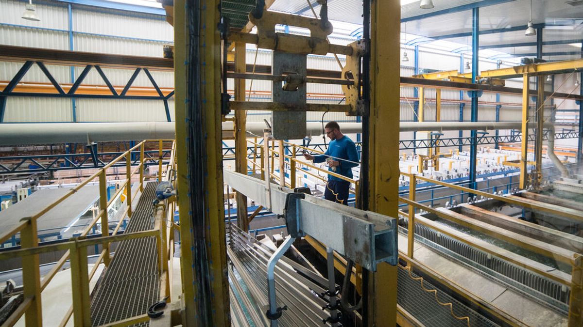 Trabajador en una fábrica de perfiles metálicos Trabajador en una fábrica de perfiles metálicos