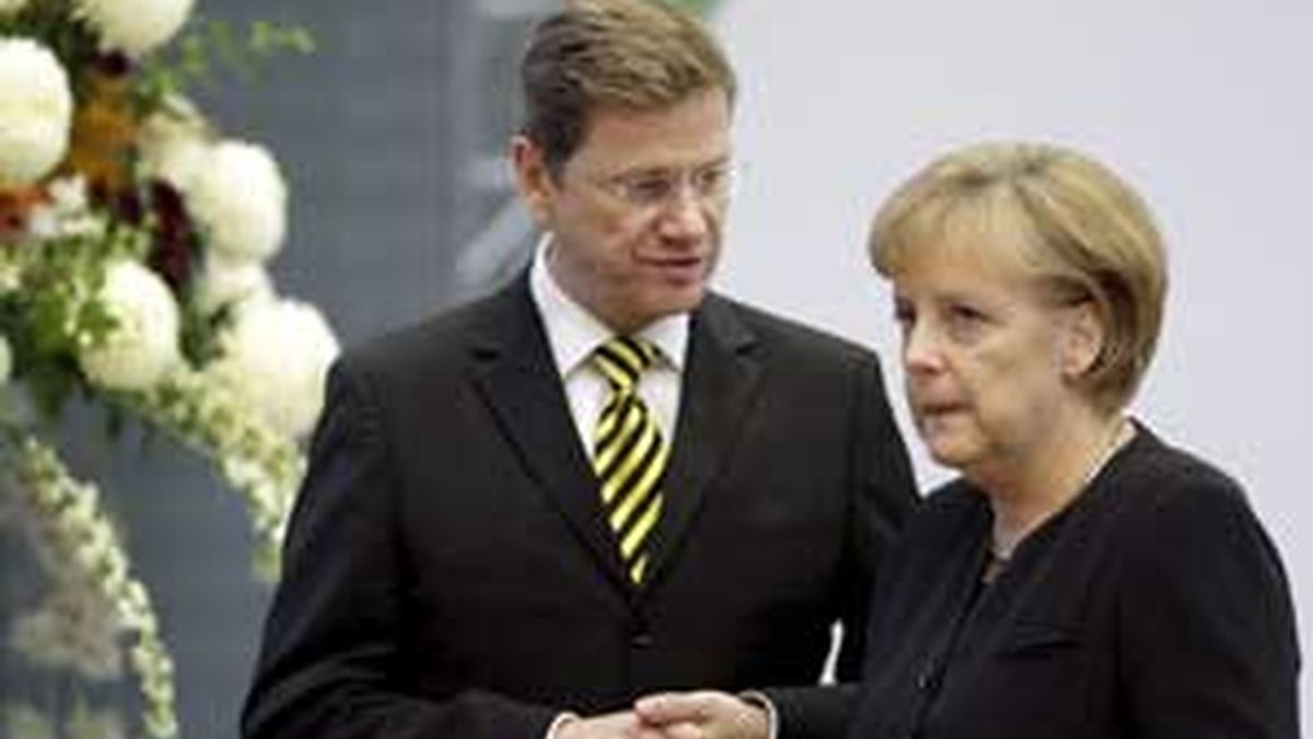 La canciller alemana, Angela Merkel, charla con el líder liberal Guido Westerwelle durante la última ronda de negociaciones para su nuevo gobierno de coalición, en Berlín. Foto: EFE