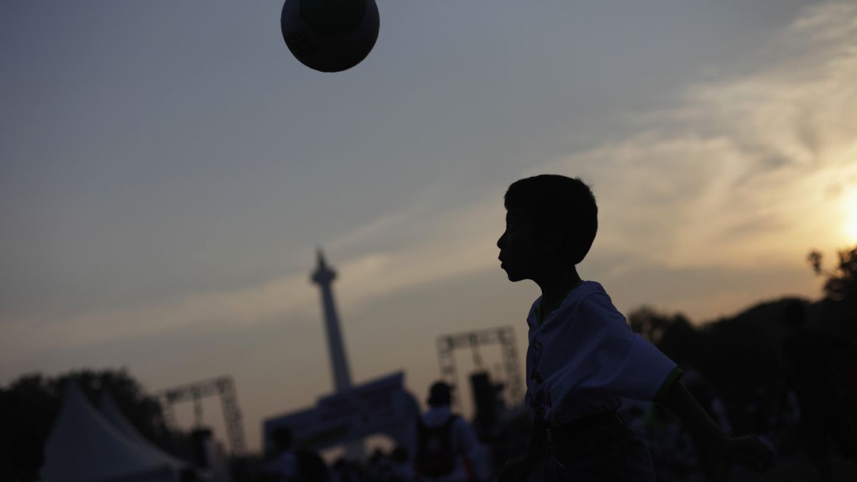 Niño jugando al fútbol en Indonesia
