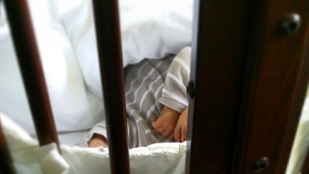 El pequeño Martín duerme la siesta en su cuna