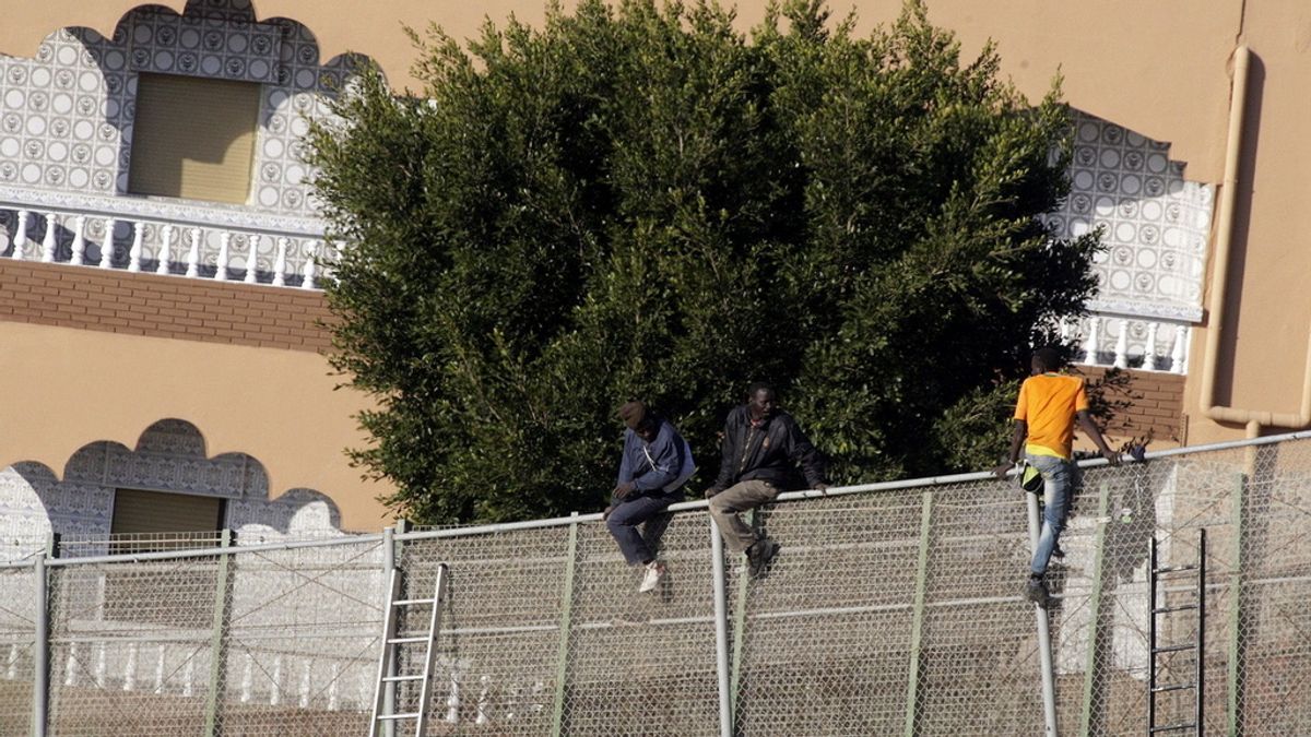 Inmigrantes encaramados a la valla fronteriza en Melilla