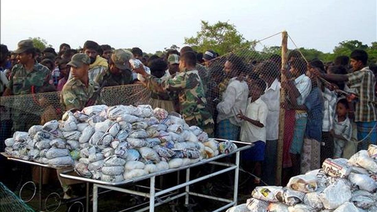 Un militar reparte comida entre los miles de civiles desplazados que viven en centros temporales en Puthumattalan (Sri Lanka), hoy, 24 de abril. Al menos 12 guerrilleros tamiles murieron y otros ocho resultaron heridos en combates librados en las últimas 24 horas en el último bastión de la guerrilla, en el noreste de Sri Lanka. EFE