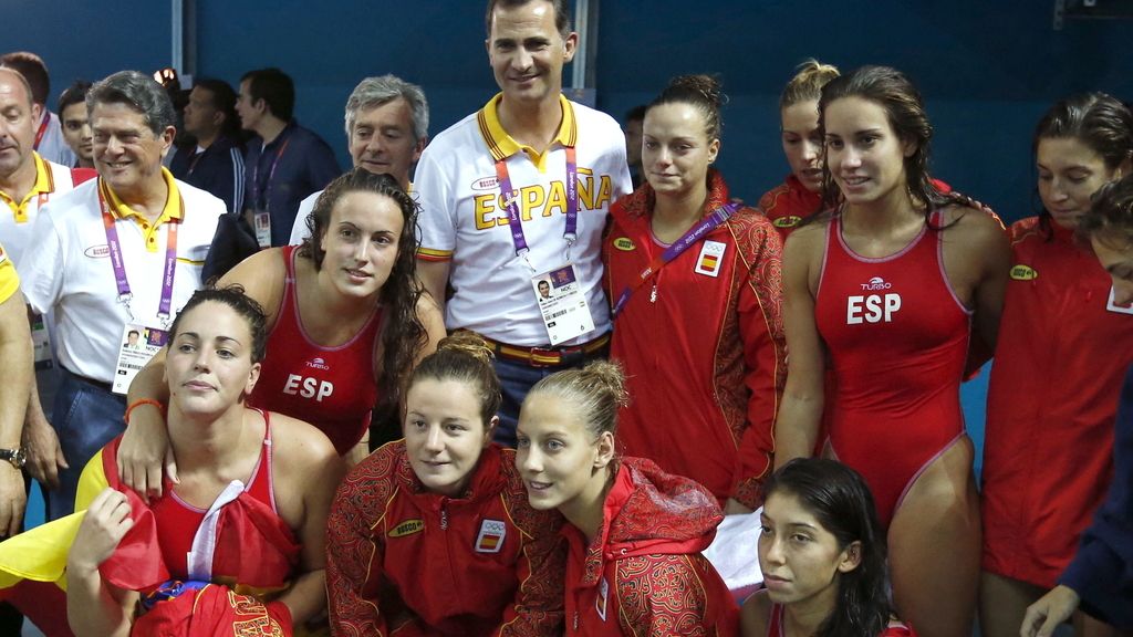 El príncipe Felipe posa con las integrantes de la selección española de waterpolo femenino, plata olímpica, tras el partido