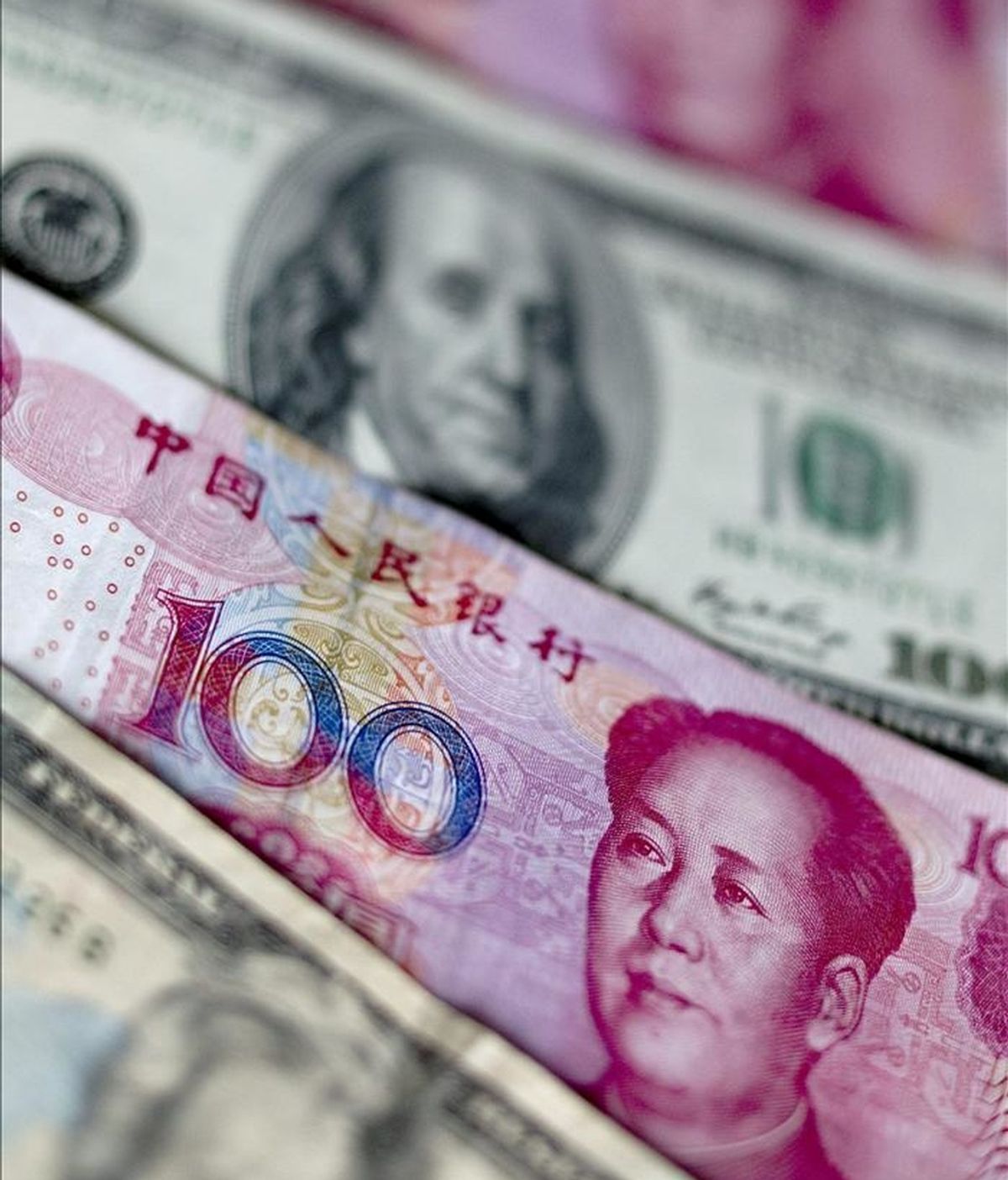 Billetes de la moneda china, el yuan y de la divisa estadounidense, el dólar, en Pekín, China. EFE/Archivo