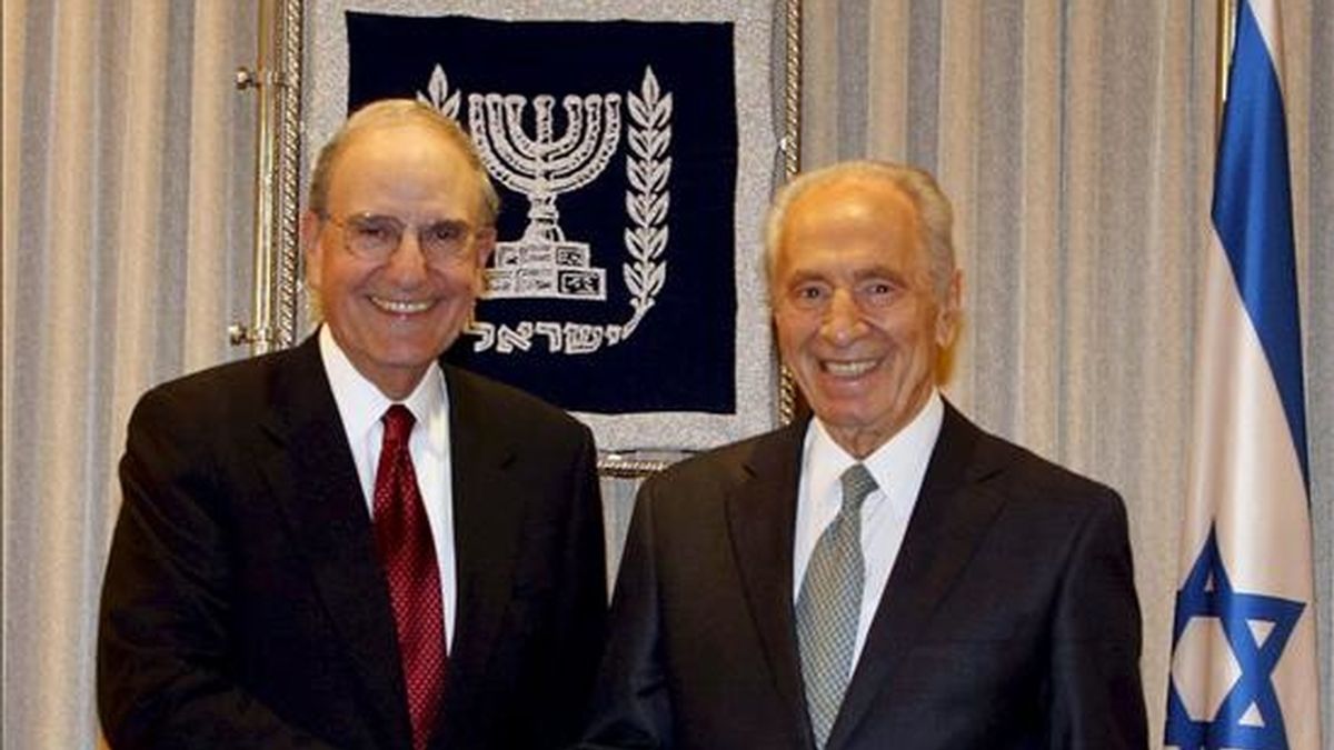 El presidente israelí, Shimon Peres (d), estrecha la mano del enviado especial de Estados Unidos para Oriente Medio, George Mitchell, durante su reunión en Tel Aviv (Israel), el 9 de junio. EFE