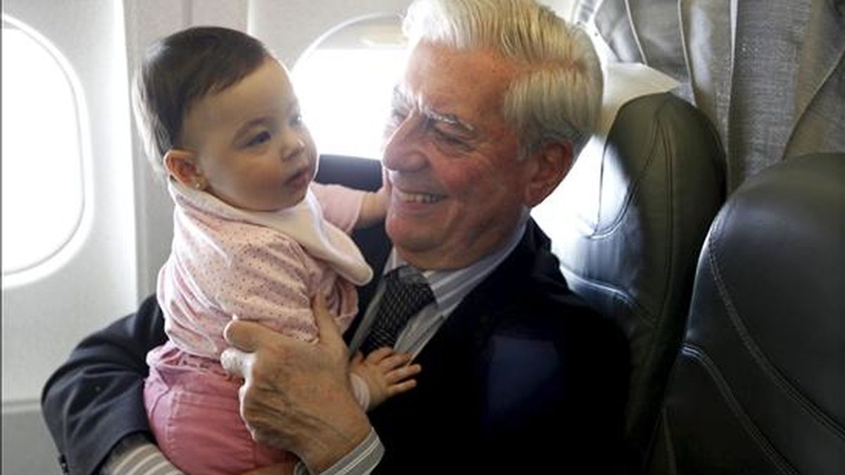 El escritor Mario Vargas Llosa juega con su nieta Anais durante el vuelo que le traslada a Estocolmo, donde el próximo viernes recibirá el Premio Nobel de Literatura. EFE