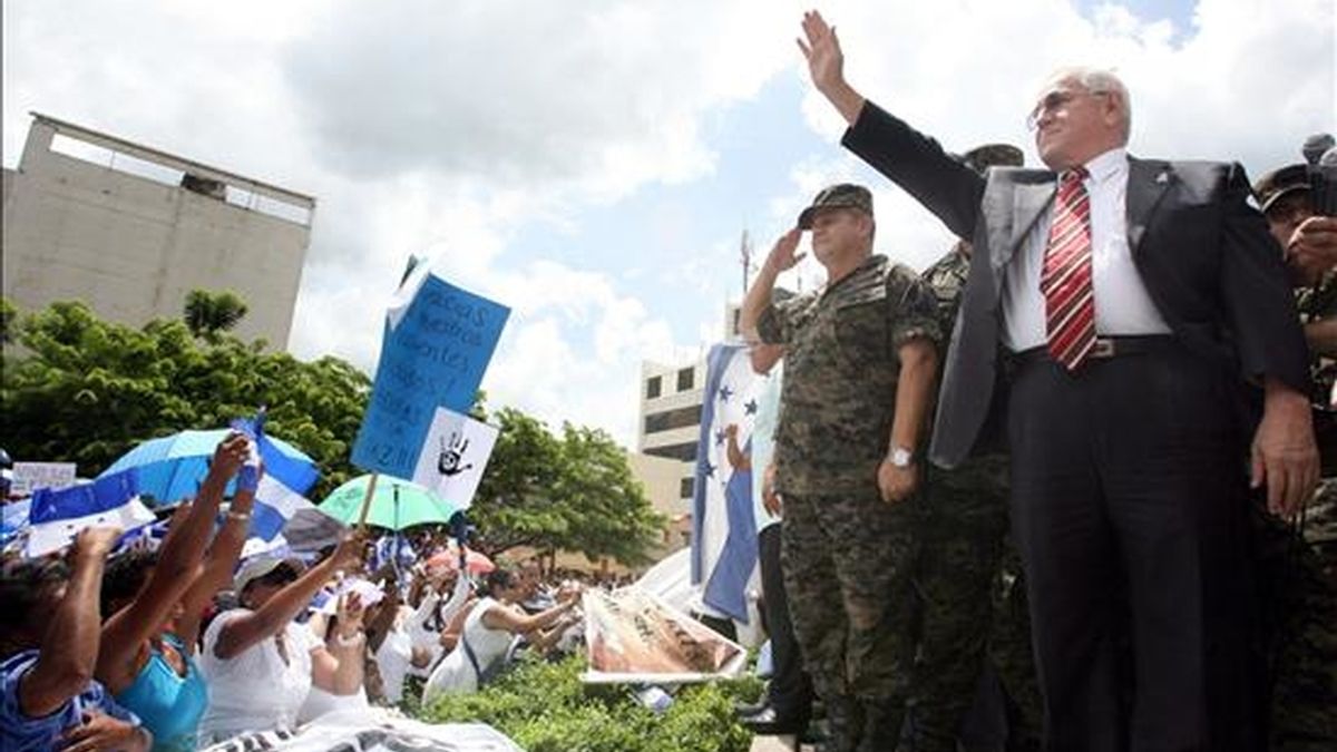 Imagen de este martes del nuevo presidente de Honduras, Roberto Micheletti (d), mientras saluda a un grupo de seguidores. EFE