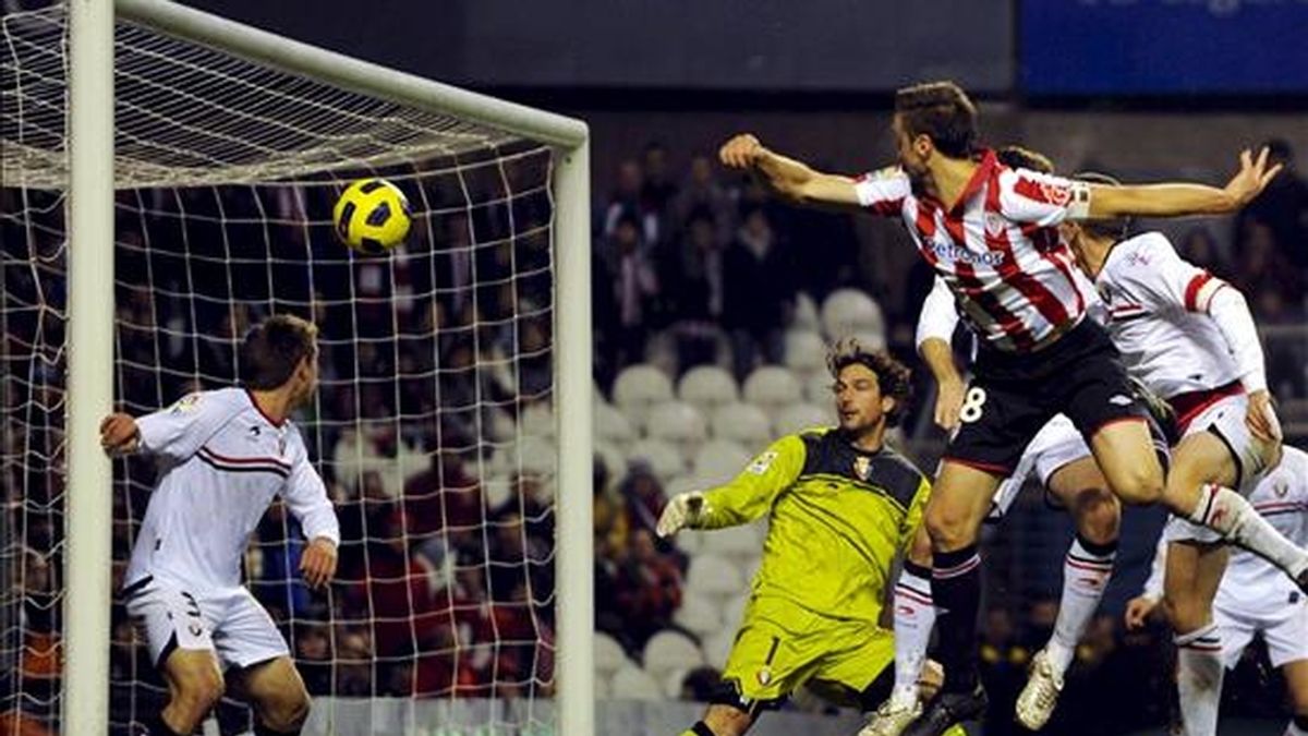 El centrocampista del Athletic de Bilbao Carlos Gurpegui (primer término) bate al portero de Osasuna, Ricardo López (c, detrás) y consigue el único gol del encuentro correspondiente a la decimotercera jornada de Liga en Primera División que se disputó en el estadio de San Mamés. EFE