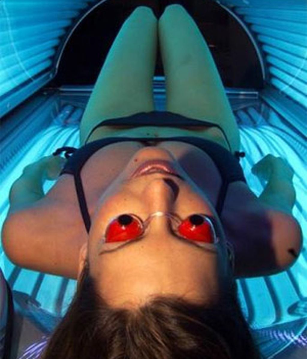 Una mujer se broncea en una cama solar. Foto: AP