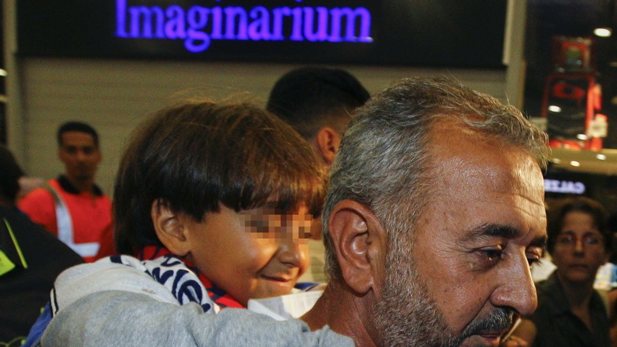 Osama Abdul Mohsen (d) y su hijo, Zaid, a su llegada a la estación de tren de Sants, en Barcelona