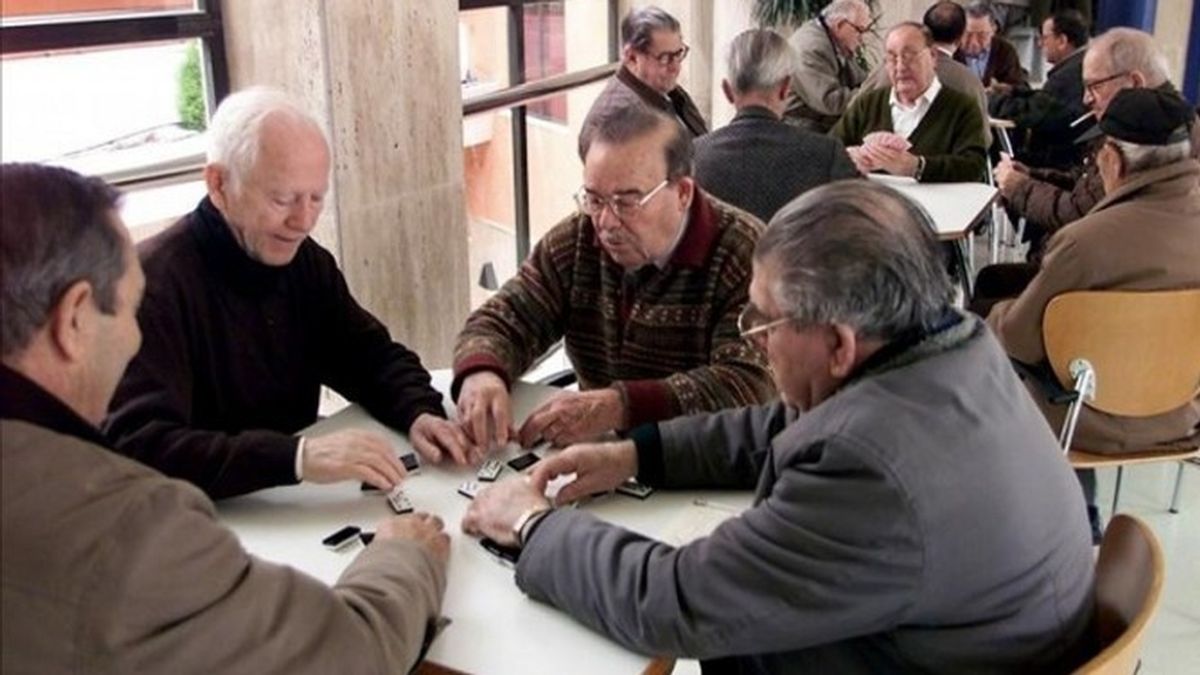 Un grupo de jubilados españoles disfrutan de su tiempo jugando al dominó