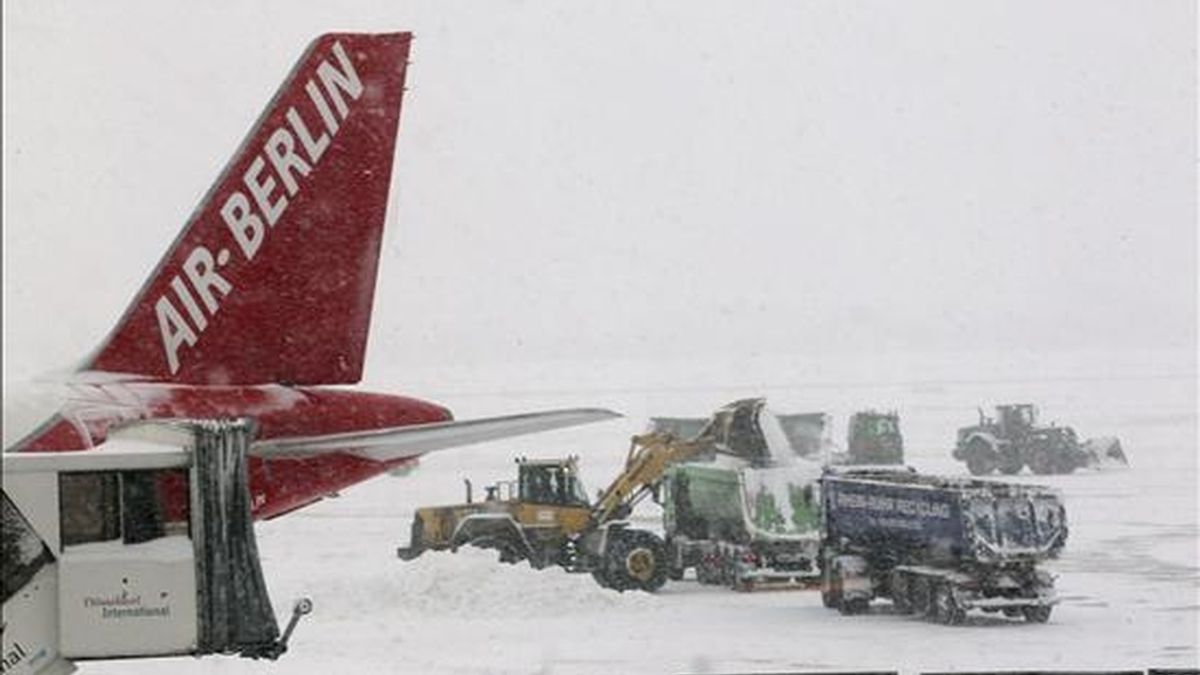 Operarios tratando de limpiar de nieve las pistas del aeropuerto de Düsseldorf (Alemania) este viernes. EFE