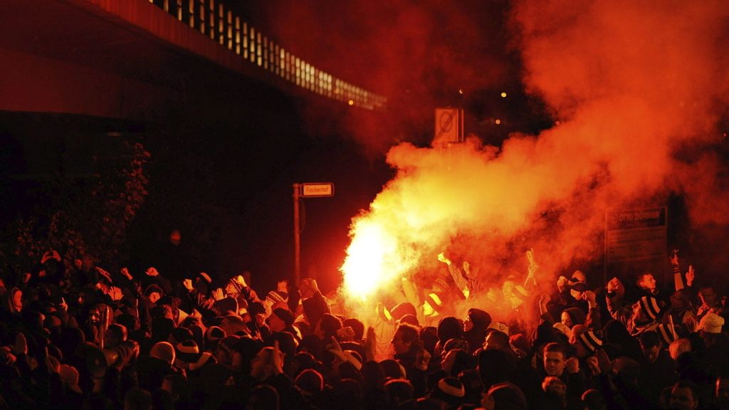 Aficionados del Dinamo Dresde encienden una bengala mientras se dirigen al estadio antes del partido de la copa alemana disputado frente al Hannover 96 en el AWD Arena de Hanover