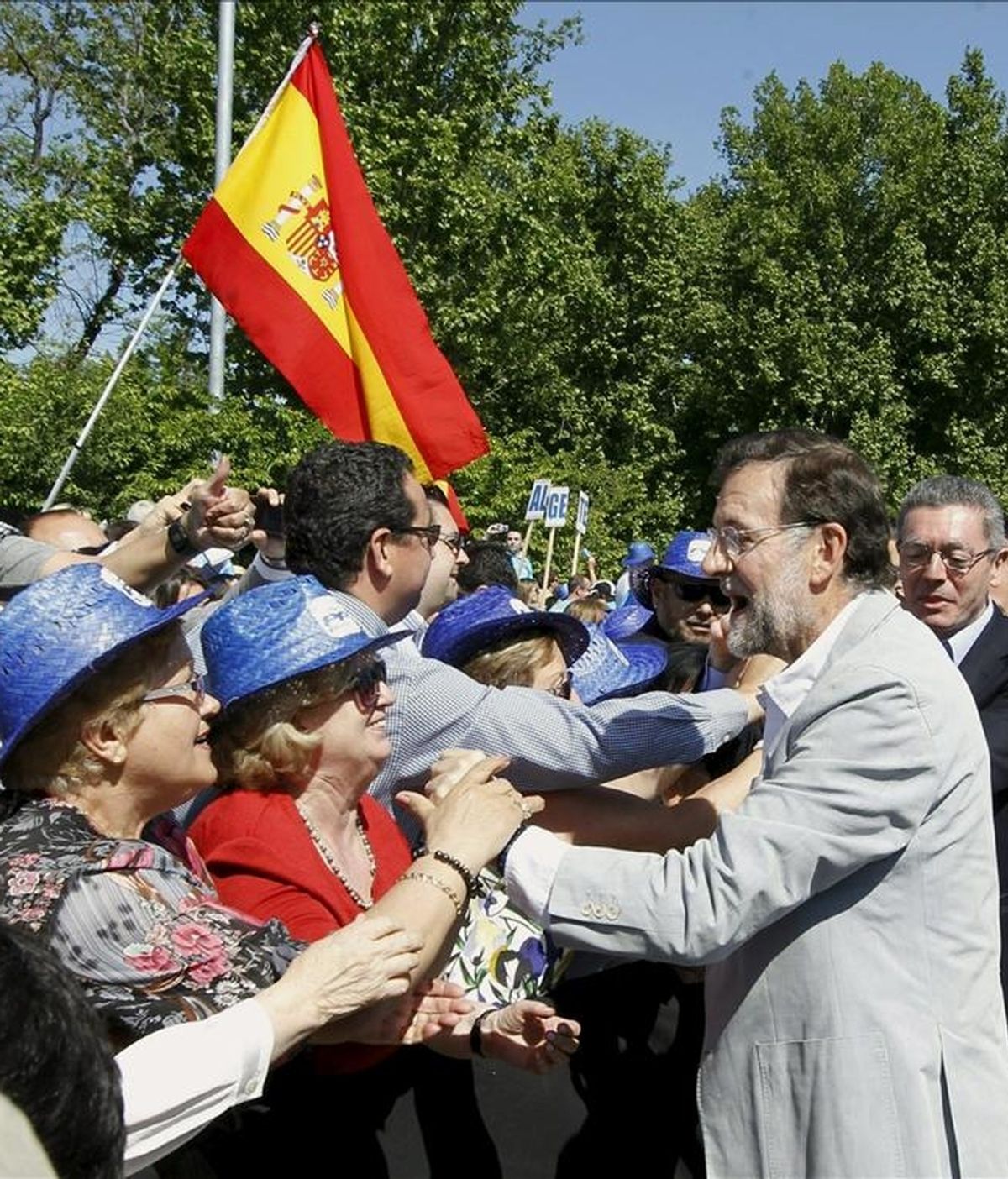 El presidente del PP, Mariano Rajoy (2d), y el alcalde de Madrid, Alberto Ruiz Gallardón (d), saludan a los asistentes a su llegada al acto principal de la jornada electoral del Partido Popular celebrado hoy en la explanada de Madrid Río. EFE