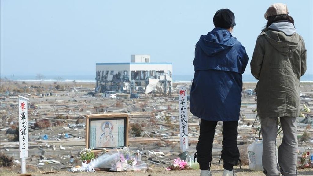 Residentes locales oran en un monumento budista hoy, 10 de abril de 2011, junto a los escombros de la devastación producida por el tsunami que destruyó a Natori (Japón). El número de muertos por el terremoto y el tsunami del 11 de marzo en el noreste de Japón se elevó a 12.985, al tiempo que otras 14.809 personas siguen desaparecidas, según el último recuento policial. EFE