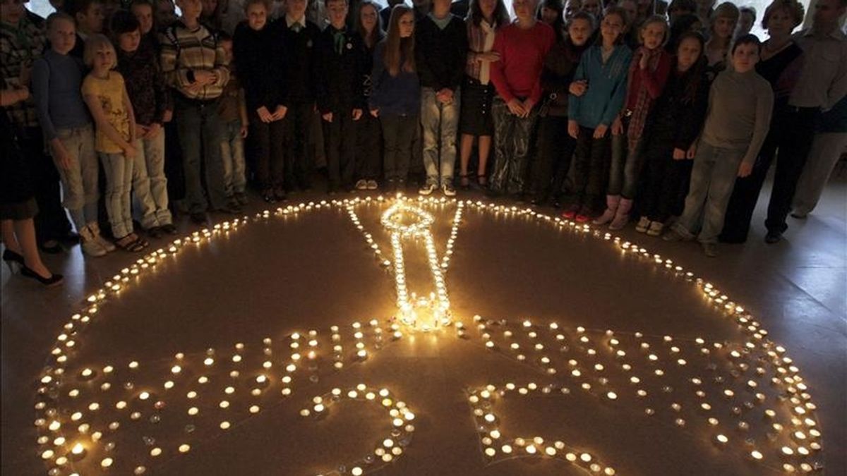 Alumnos y profesonres del Instituto Ecológigo de Minsk, Bielorrusia, encienden velas con motivo de los actos por el 25º aniversario del accidente en la central nuclear ucraniana de Chernóbil, en Misnk, Bielorrusia. EFE