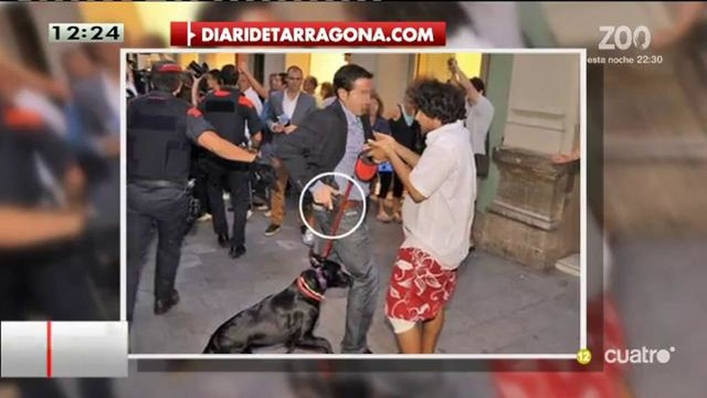 Un escolta de Rajoy echa mano al cinto ante un manifestante contra Rajoy en Reus