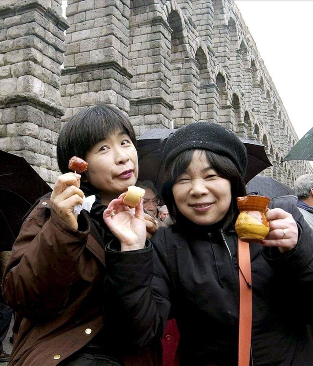 Dos turistas japonesas disfrutan de la gastronomía típica en Segovia. EFE/Archivo