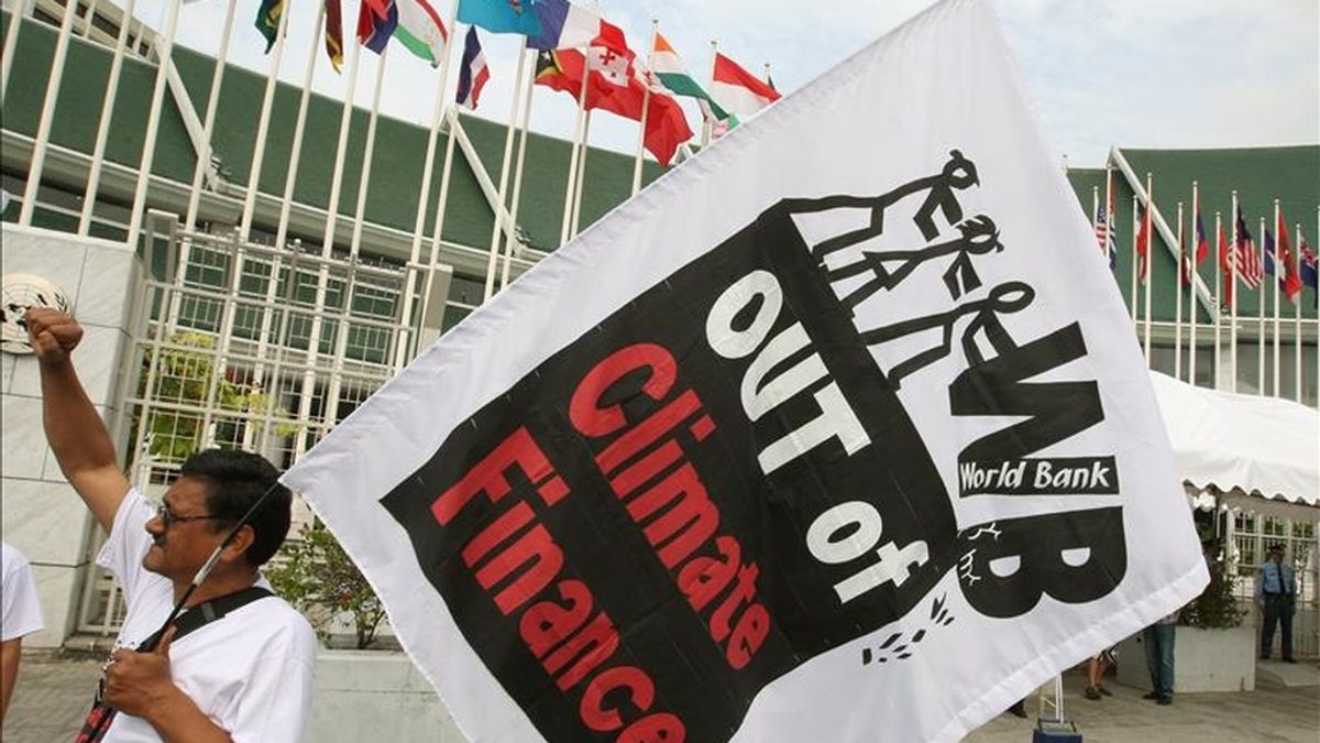 Activistas sostienen banderas con un eslogan que dice "Fuera el Banco Mundial de la Financiación Climática" durante una manifestación hoy, frente al Centro de la Conferencia de Naciones Unidas en Bangkok (Tailandia). EFE