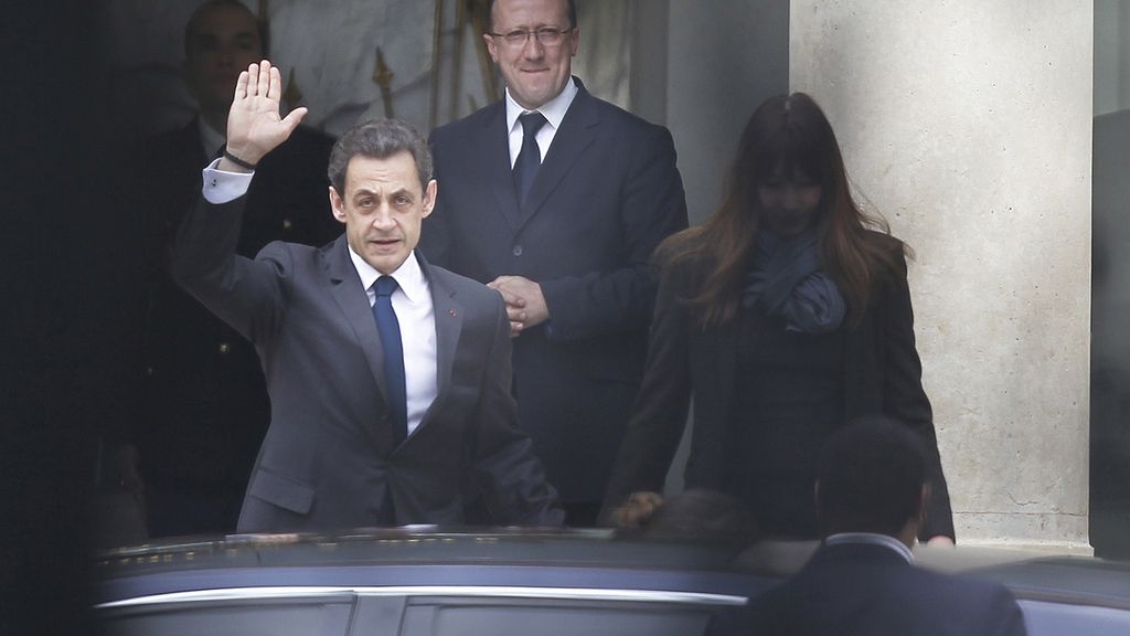 El presidente francés Nicolás Sarkozy sale del Elíseo con su esposa Carla Bruni