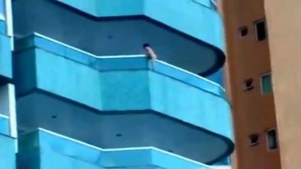 Un niño cuelga de una cornisa en un edificio de Brasil
