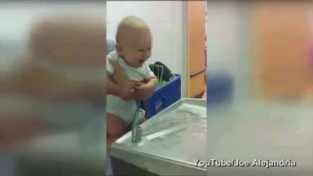 Un adorable bebé contagia su risa mientras él se divierte con una fuente
