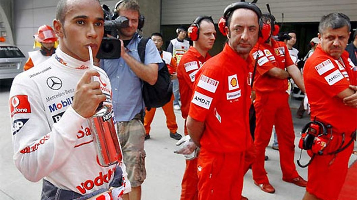 Lewis Hamilton, observado por un grupo de mecánicos de Ferrari. FOTO: Archivo.