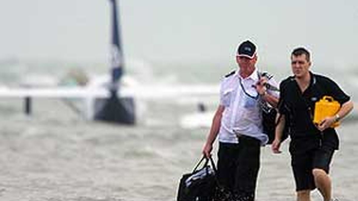 El piloto Steve Bolle y un pasajero caminan hacia la playa tras el aterrizaje forzoso. Foto:AP