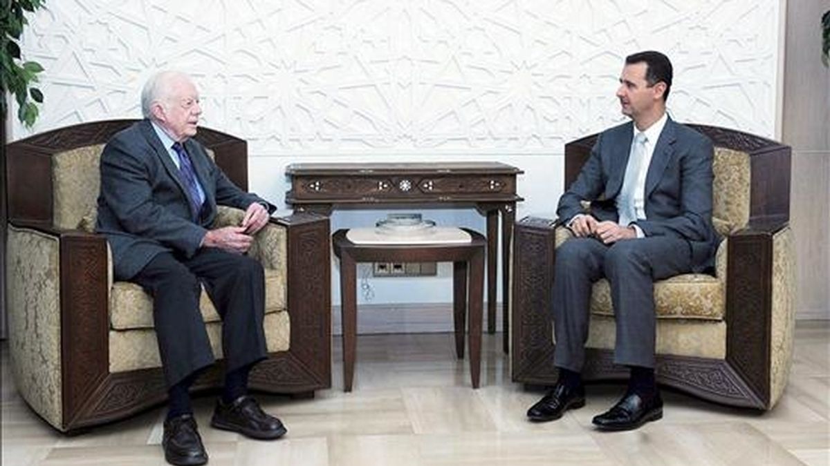 El presidente sirio, Bachar Al Assad (d), conversa con el ex presidente de Estados Unidos, Jimmy Carter, durante el encuentro que mantuvieron en Damasco, Siria, hoy jueves 11 de junio, en el que abordaron el proceso de paz en Oriente Medio. EFE