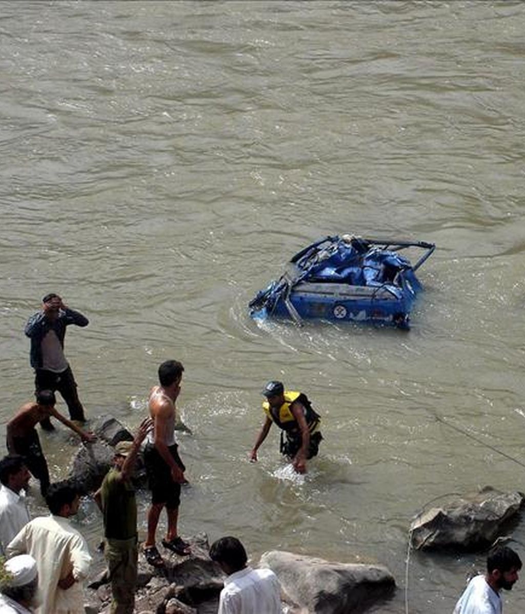 Rescatistas buscan los restos de un autobus escolar que se precipitó por un barranco cerca de Muzaffarabad, la capital de la parte paquistaní de Cachemira. EFE