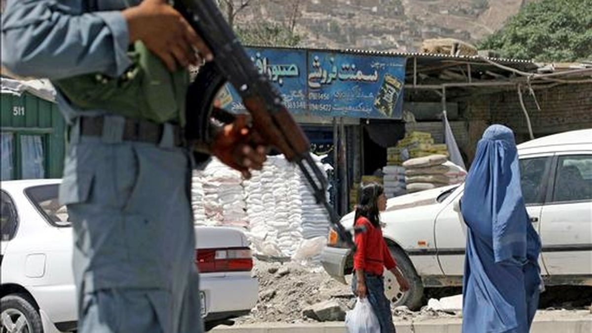 Un policía afgano vigila cerca del puesto de control montado en una carretera hoy, lunes 19 de julio de 2010 en Kabul (Afganistán) un día antes de la conferencia internacional de donantes de Kabul. Delegados de más de 70 países y organizaciones participarán en la cumbre. EFE