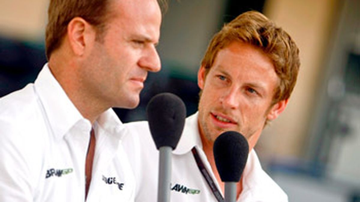Los pilotos de Fórmula Uno de la escudería Brawn GP, el brasileño Rubens Barrichelo (izda) y el británico Jenson Button, atienden a los medios en el circuito de Bahrein (BIC). Foto: EFE.
