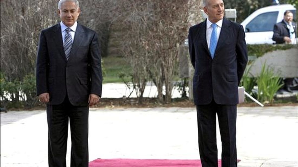 El nuevo primer ministro israelí, Benjamin Netanyahu (i), y su antecesor Ehud Olmert asisten a la ceremonia de traspaso de poderes en la residencia de Peres en Jerusalén (Israel). EFE