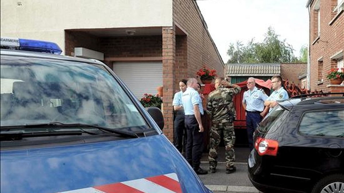 Miembros de la Gendarmería francesa esperan de pie delante de una casa en Villers-au-Tertre, cerca de Lille, al norte de Francia. EFE