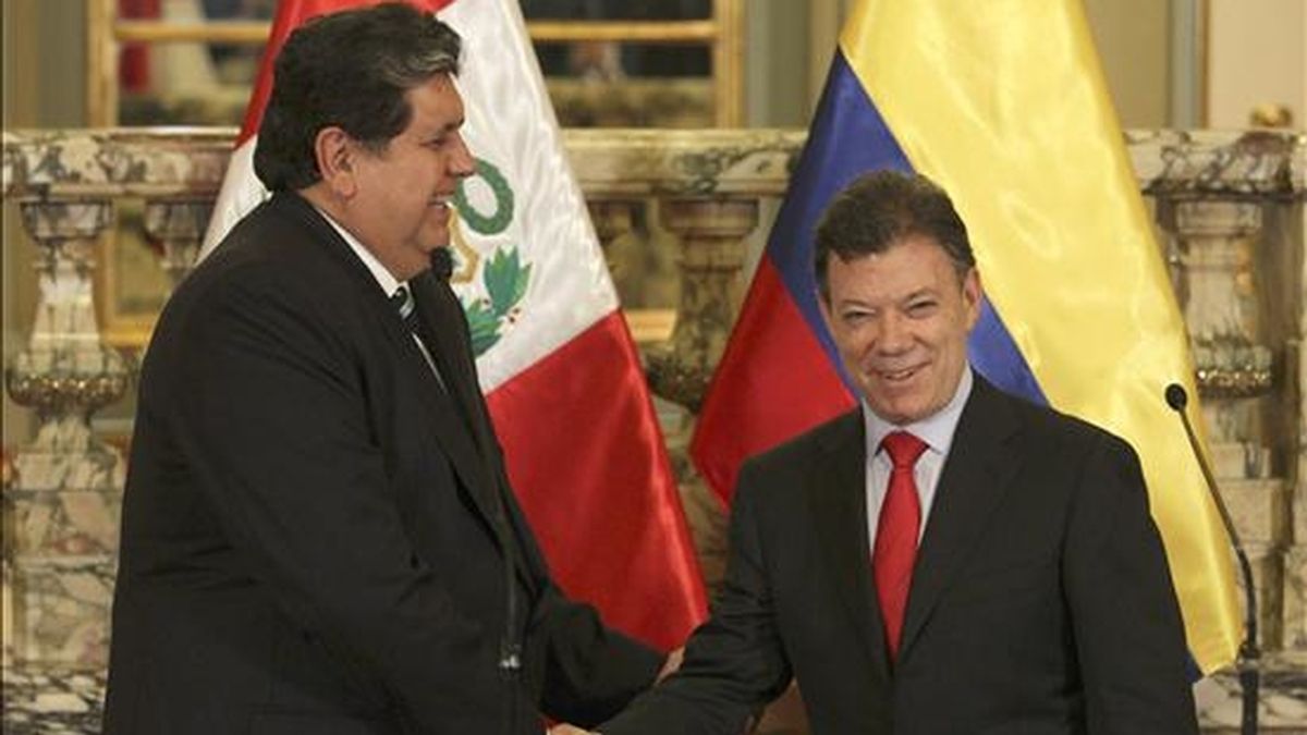El presidente electo de Colombia, Juan Manuel Santos (d), estrecha la mano del mandatario peruano, Alan García (i), el pasado 27 de julio de 2010, durante una reunión en el Palacio de Gobierno en Lima (Perú). EFE/Archivo