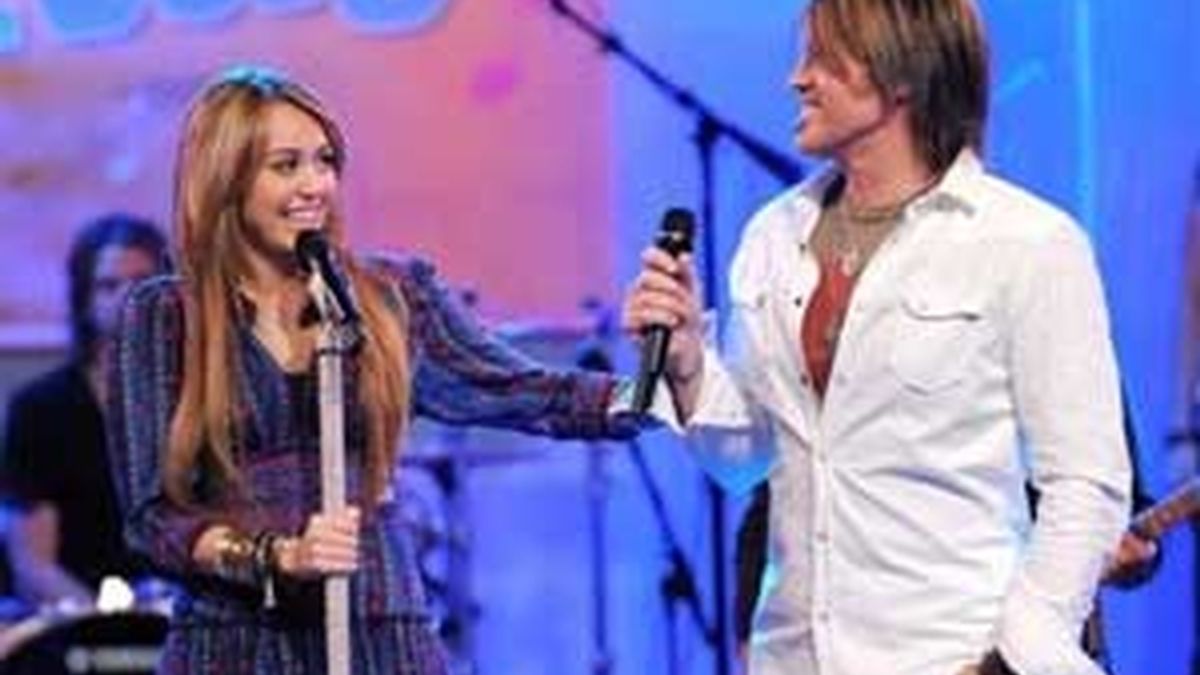 Miley Cyrus junto a su padre, el cantante de country Billy Ray Cyrus, durante un acto de promoción de la película. FOTO: AP