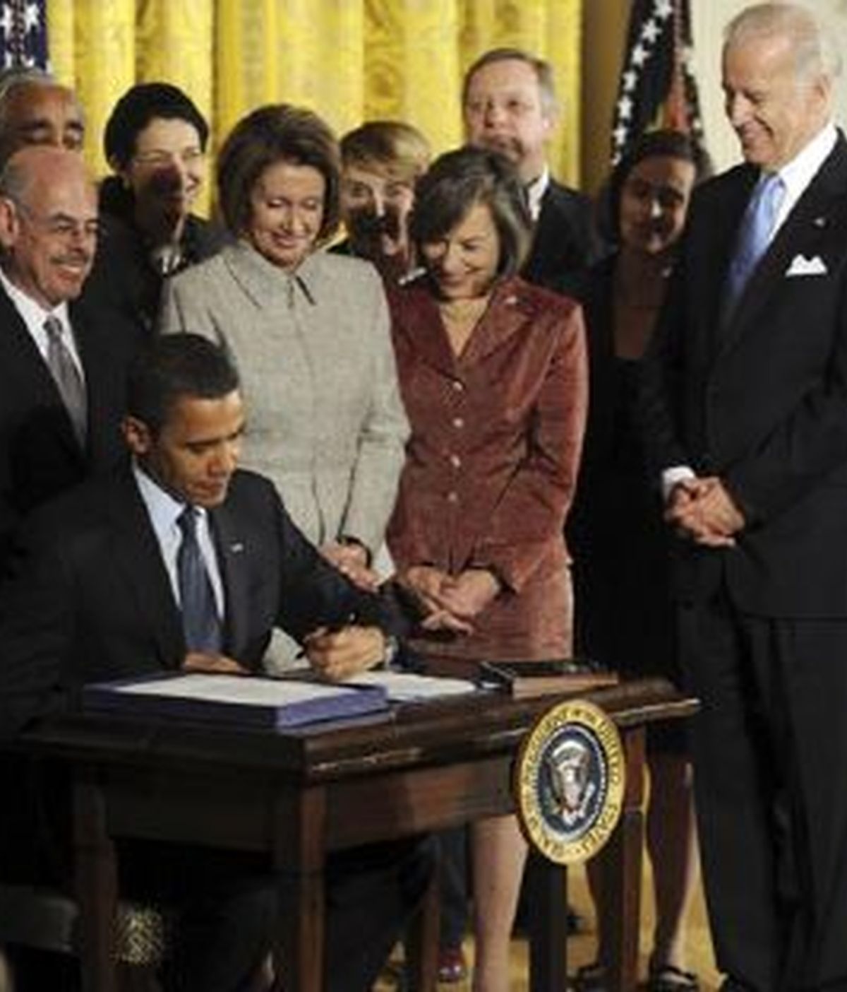 El presidente de Estados Unidos, Barack Obama (i-abajo), firma en presencia del vicepresidente, Joseph Biden (d), y la presidenta de la Cámara de Representantes, Nancy Pelosi (c-arriba), la Ley de Seguridad Médica para la Infancia. Foto: EFE