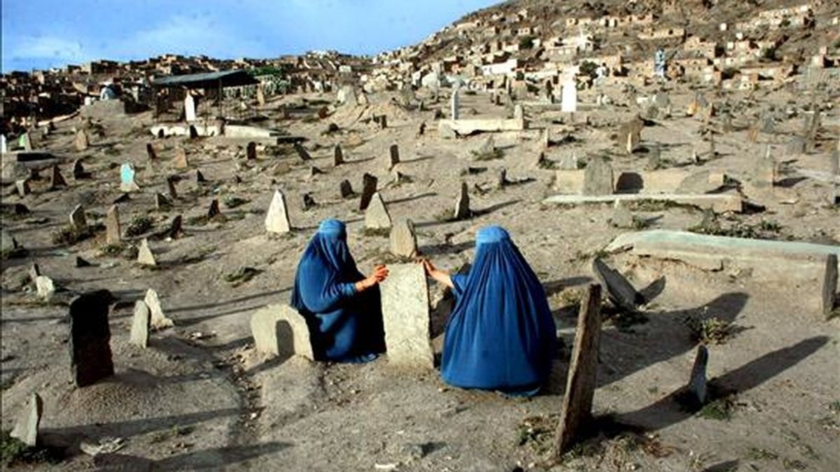 Dos mujeres afganas vestidas con burkas visitan las tumbas de algunos de sus familiares, en un cementerior de Kabul, Afganistán. El secretario de Defensa estadounidense, Robert Gates, advirtió hoy de que se espera una estación estival de "fuertes enfrentamientos" en Afganistán, por la presión que supondrá para la insurgencia la llegada de nuevas tropas de la Fuerza Internacional de Asistencia a la Seguridad (ISAF). EFE