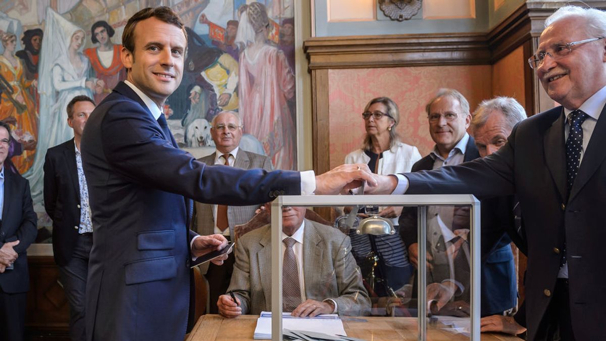Los sondeos a pie de urna dan a los aliados de Macron una clara mayoría absoluta