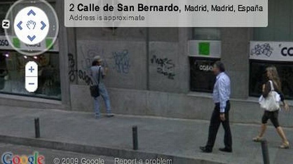 Un hombre hace pintadas en la pared de una calle de Madrid