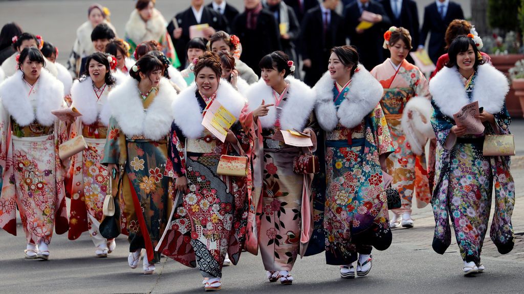 Mujeres japonesas vestidas con kimonos asisten a la ceremonia de celebración del Día de la mayoría de edad en un parque de diversiones en Tokio, Japón