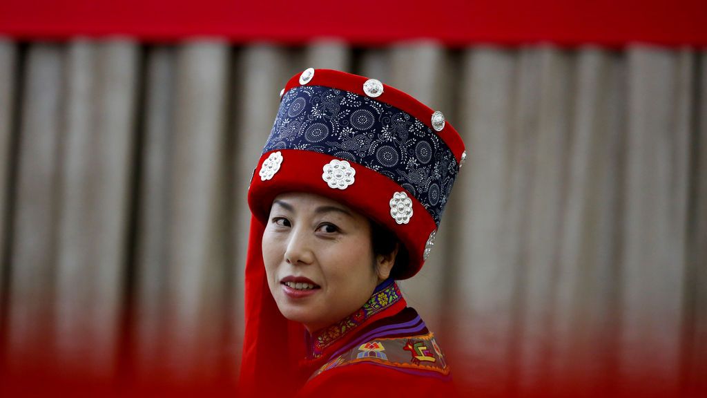 Una mujer asiste, con el atuendo tradicional, a una conferencia de prensa del municipio de Chongqing en China